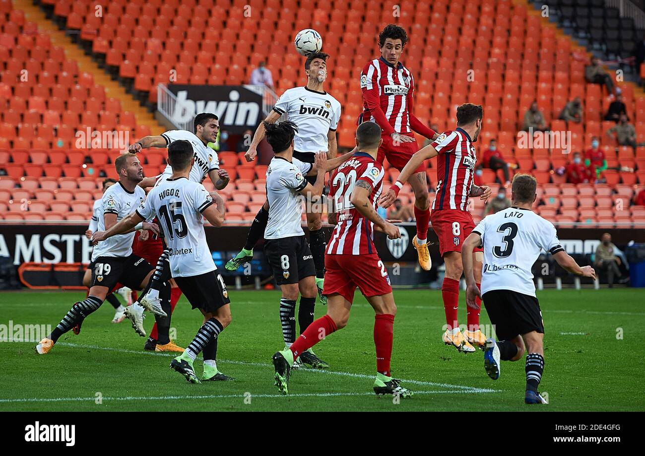 Valencia, Spain. 28th Nov, 2020. Valencia's Gabriel Paulista (top L) vies with Atletico de Madrid's Jose Maria Gimenez (top R) during a Spainsh league match between Valencia CF and Atletico de Madrid at Estadio Mestalla in Valencia, Spain, Nov. 28, 2020. Credit: Pablo Morano/ Xinhua/Alamy Live News Stock Photo