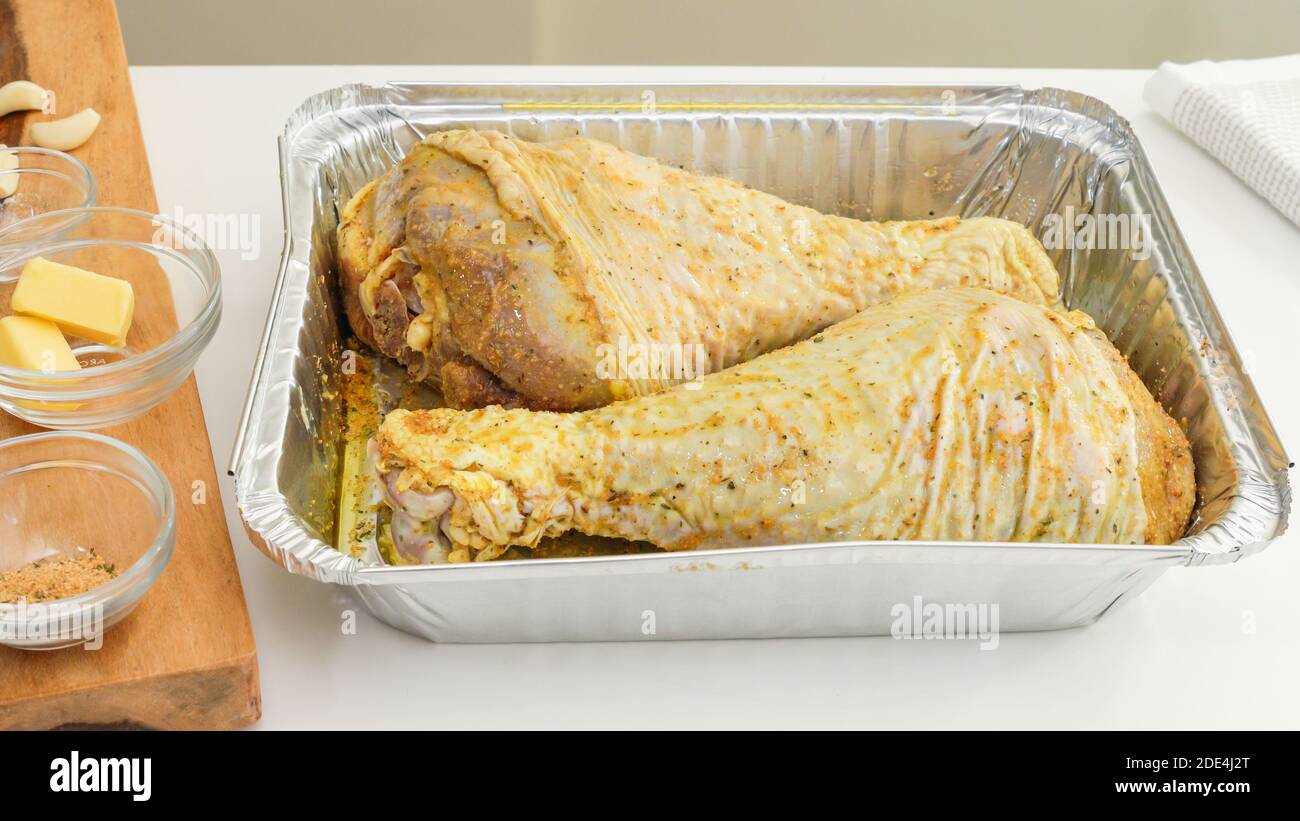 https://c8.alamy.com/comp/2DE4J2T/marinated-turkey-legs-in-a-disposable-bake-ware-pan-close-up-on-white-kitchen-table-ready-to-be-cooked-close-2DE4J2T.jpg