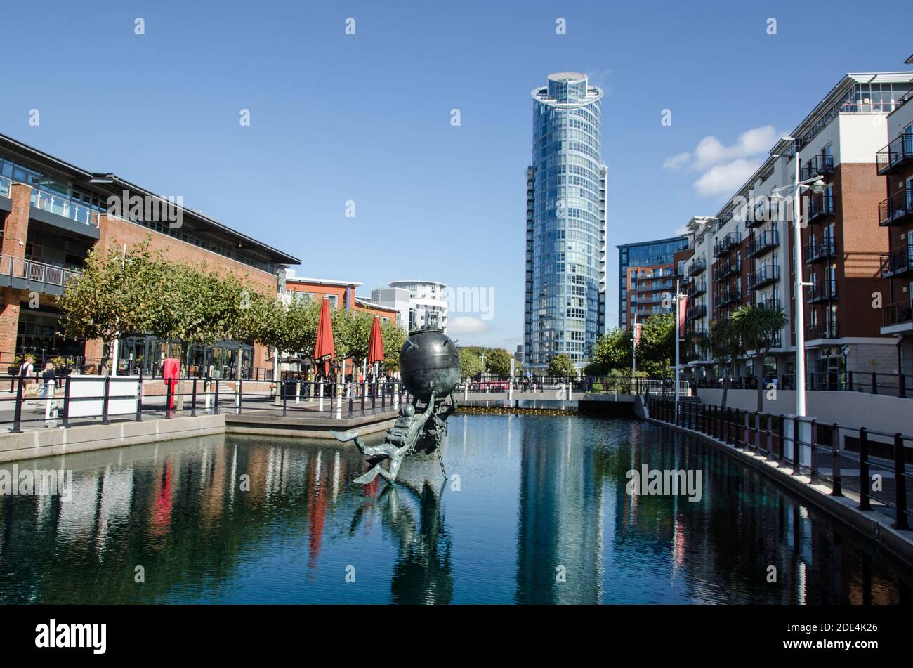 Portsmouth, UK - September 8, 2020: View along one of the converted docks at Gunwharf Quays, Portsmouth with the Vernon Monument to Royal Navy divers Stock Photo