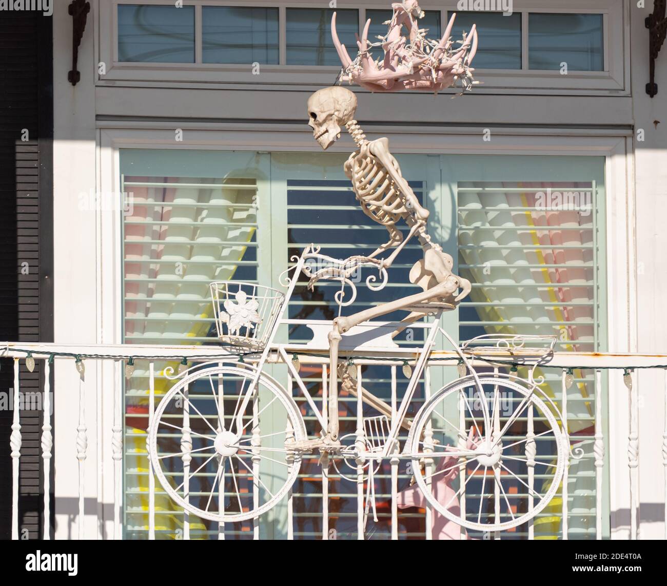 Halloween decoration, skeleton on the bicycle. Selective focus, street photo, travel photo. Stock Photo