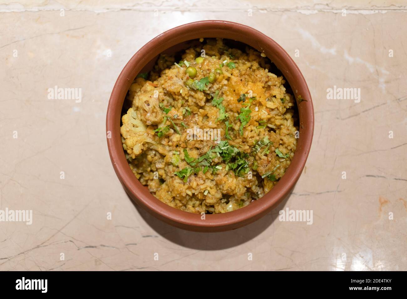 Khichdi is a dish in South Asian cuisine made of rice and lentils, but other variations include bajra and mung dal kichri. Stock Photo