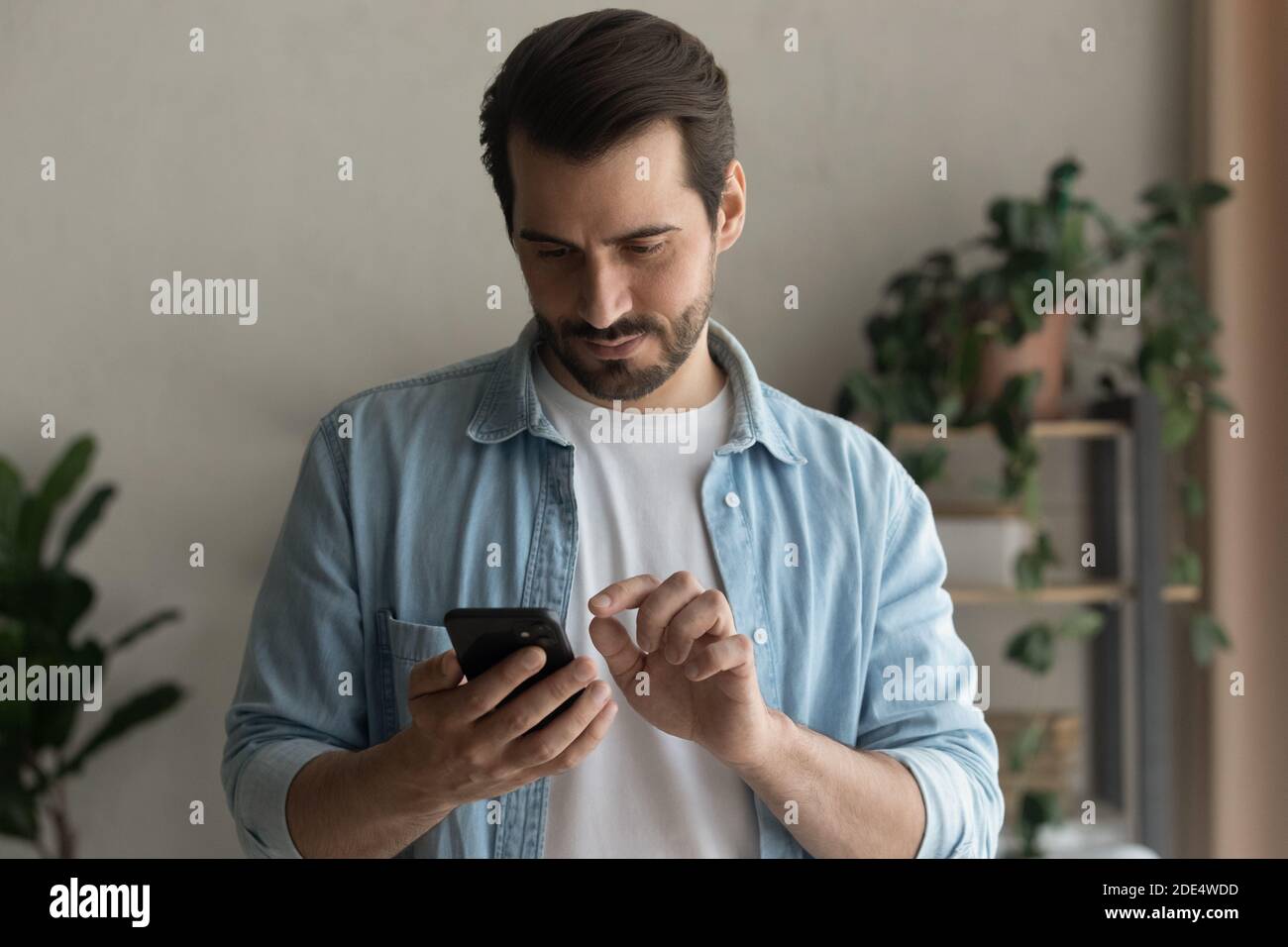 Focused caucasian man browsing phone hi-res stock photography and ...