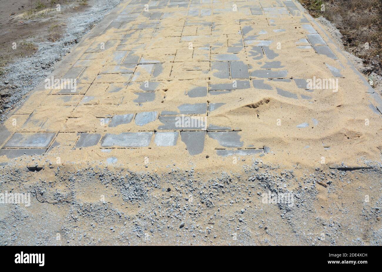 Pavers  installation and covered sand for house garden pathway. Stock Photo