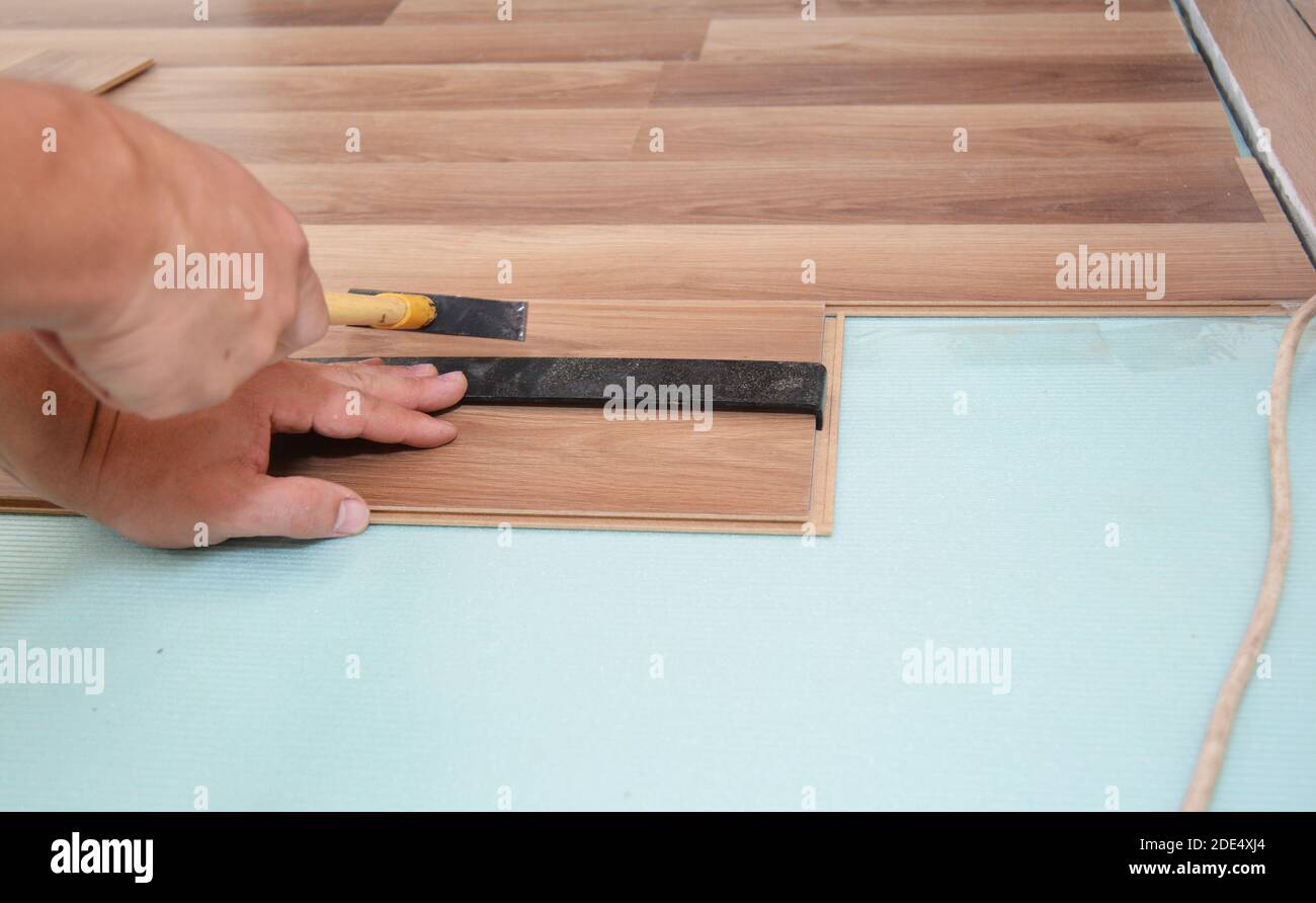 Worker Installing Wooden Laminate Flooring with Tools Stock Photo Alamy