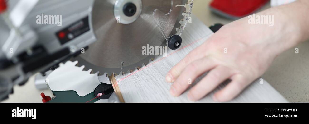 Man uses circular saw table while cutting laminate Stock Photo Alamy