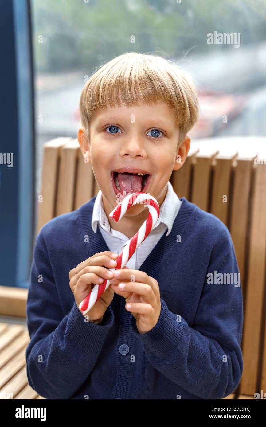 Child eating candy cane hires stock photography and images Alamy