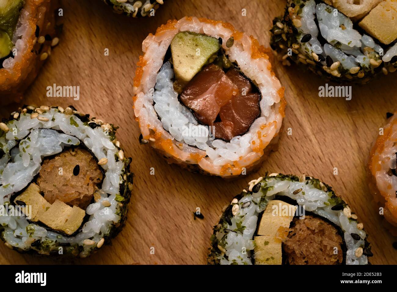 Woman using bamboo rolling mat for home made sushi Stock Photo - Alamy