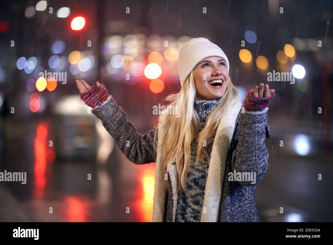 Close up portrait of a female walking outside on a snowy winter night Stock Photo