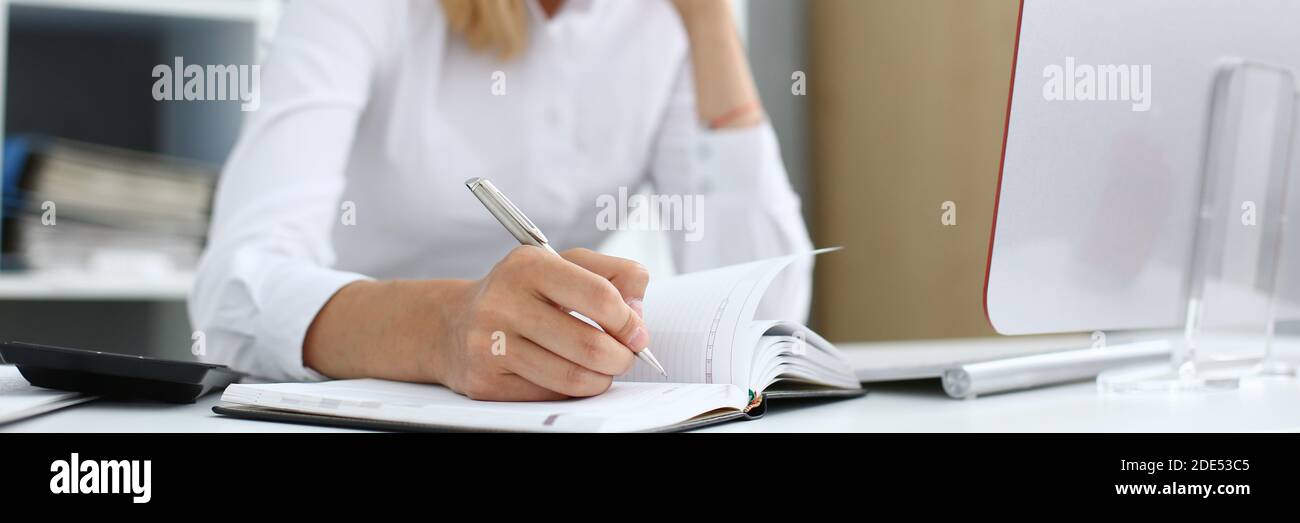 Focused photo on female hand that making notes Stock Photo