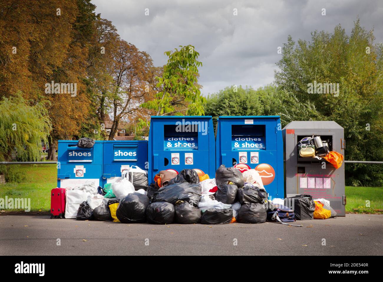stacked up rubbish by recycle bin that need collecting Stock Photo Alamy