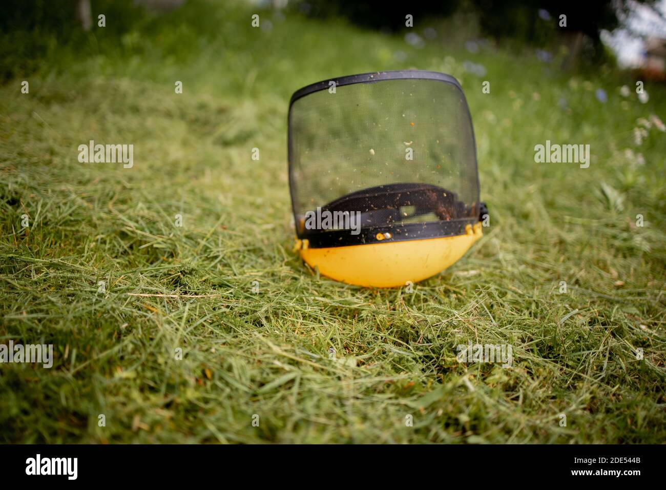Protective helmet for the mower on cut grass Stock Photo - Alamy