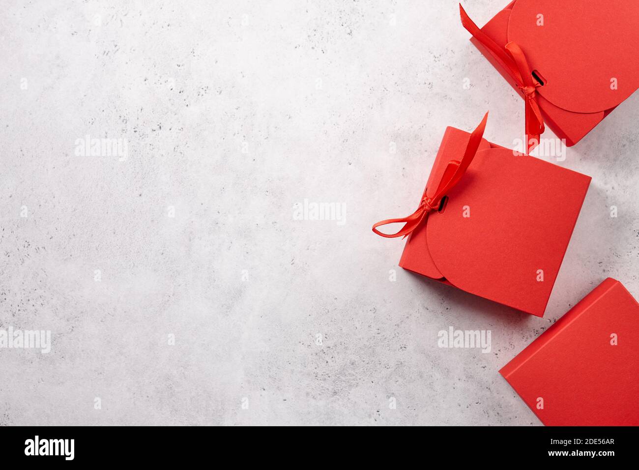 Red Christmas gift boxes on white textured background Stock Photo
