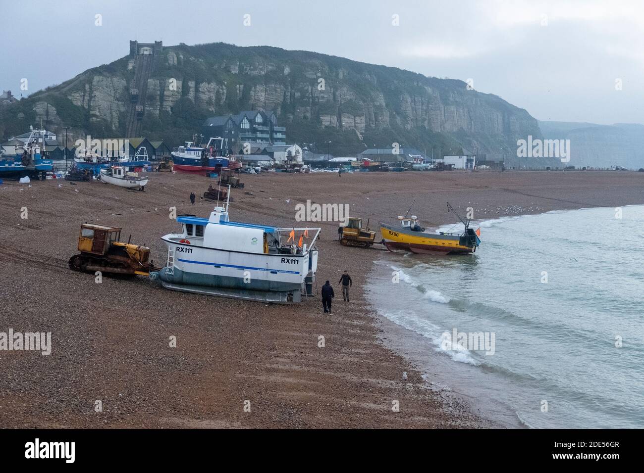 Hastings, East Sussex, UK. 29th November 2020. Hastings fishing boats put out to sea at dawn on a chilly grey Sunday morning. Stock Photo