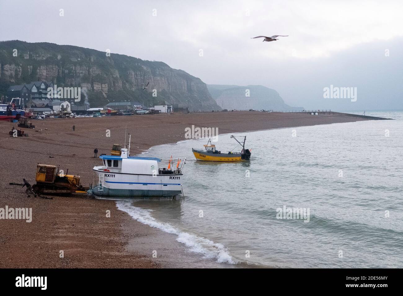Hastings, East Sussex, UK. 29th November 2020. Hastings fishing boats put out to sea at dawn on a chilly grey Sunday morning. Stock Photo
