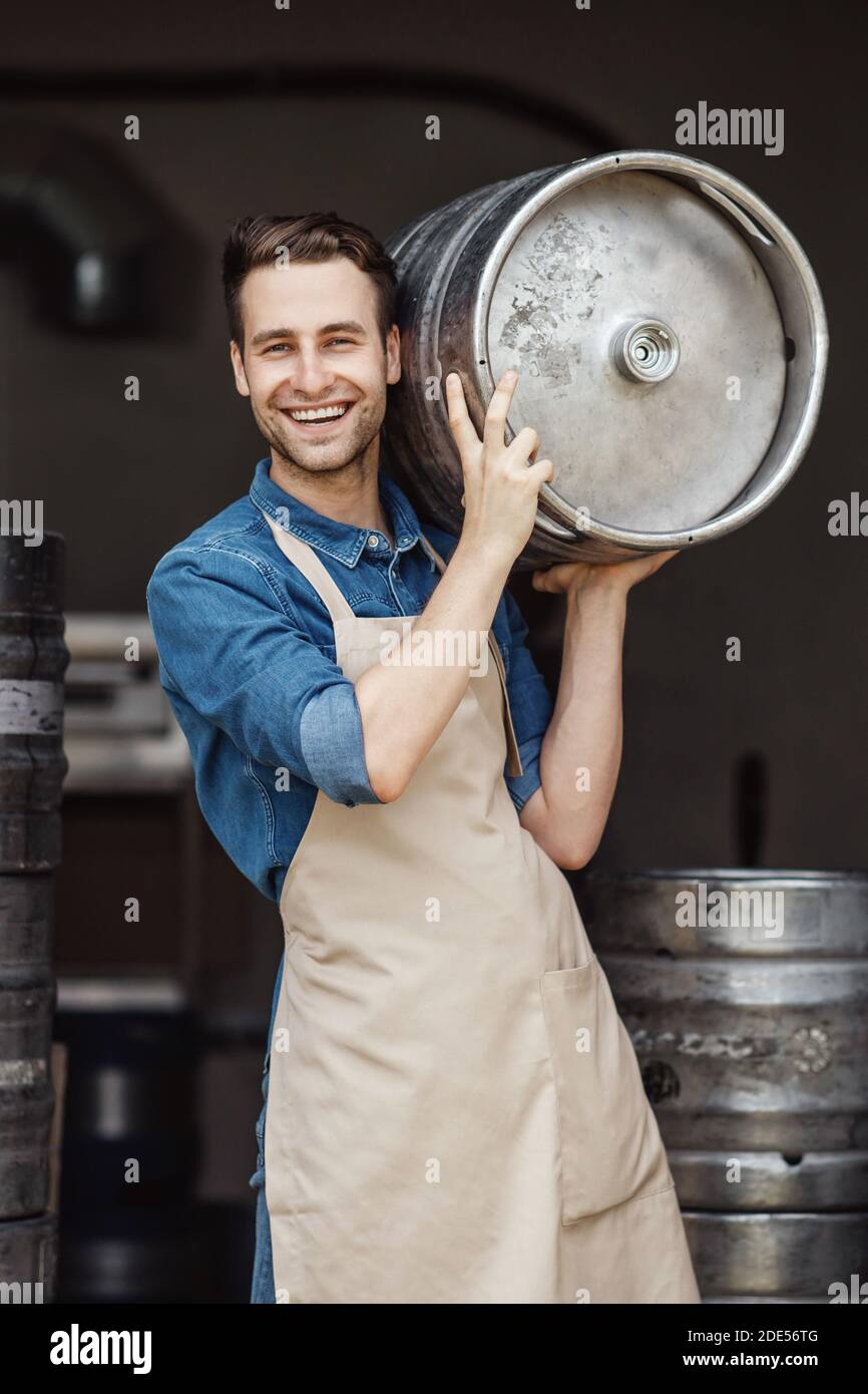 Products for beer fermentation and employee on modern brewery Stock Photo