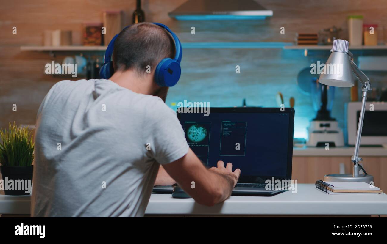 Remote man thief with headset stealing data from company hacking system  from home. Programmer writing a dangerous malware for cyber attacks using  performance device during midnight Stock Photo - Alamy