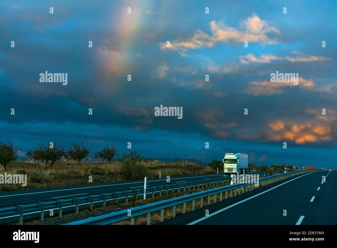 White truck with refrigerated semi-trailer driving on a highway at ...