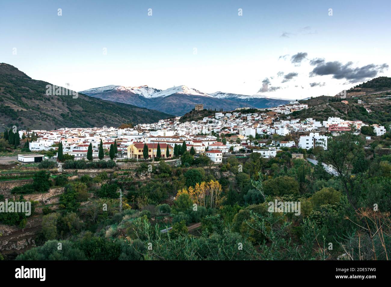 Velez de Benaudalla, a town near the coast of Granada with an Arab castle and Sierra Nevada in the background. Stock Photo