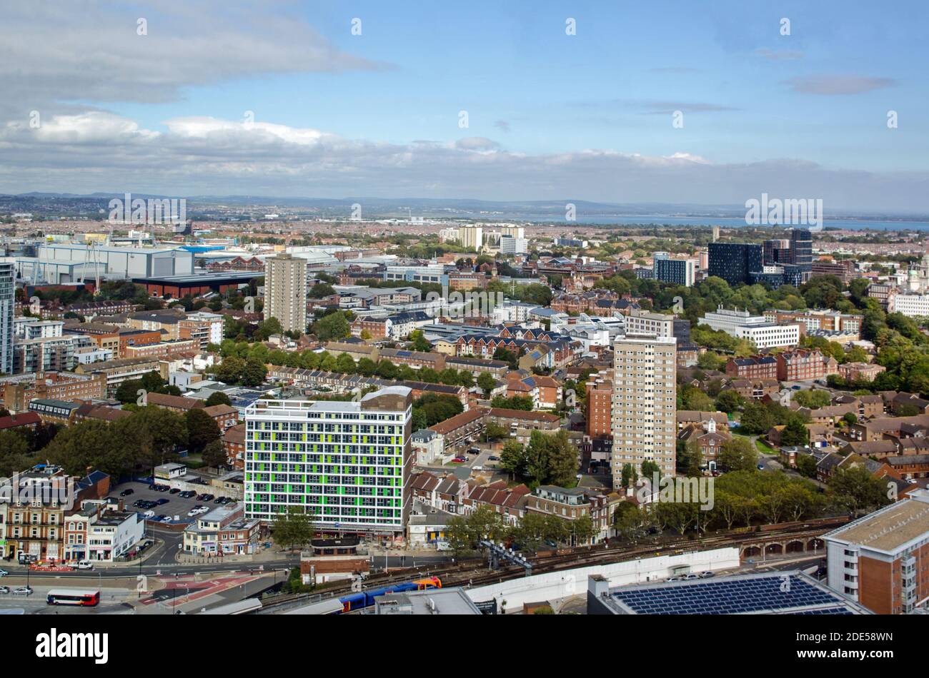 Aerial view across the tower blocks and offices of Portsmouth City Centre on a sunny day in Hampshire.  Portsmouth Harbour railway station is towards Stock Photo