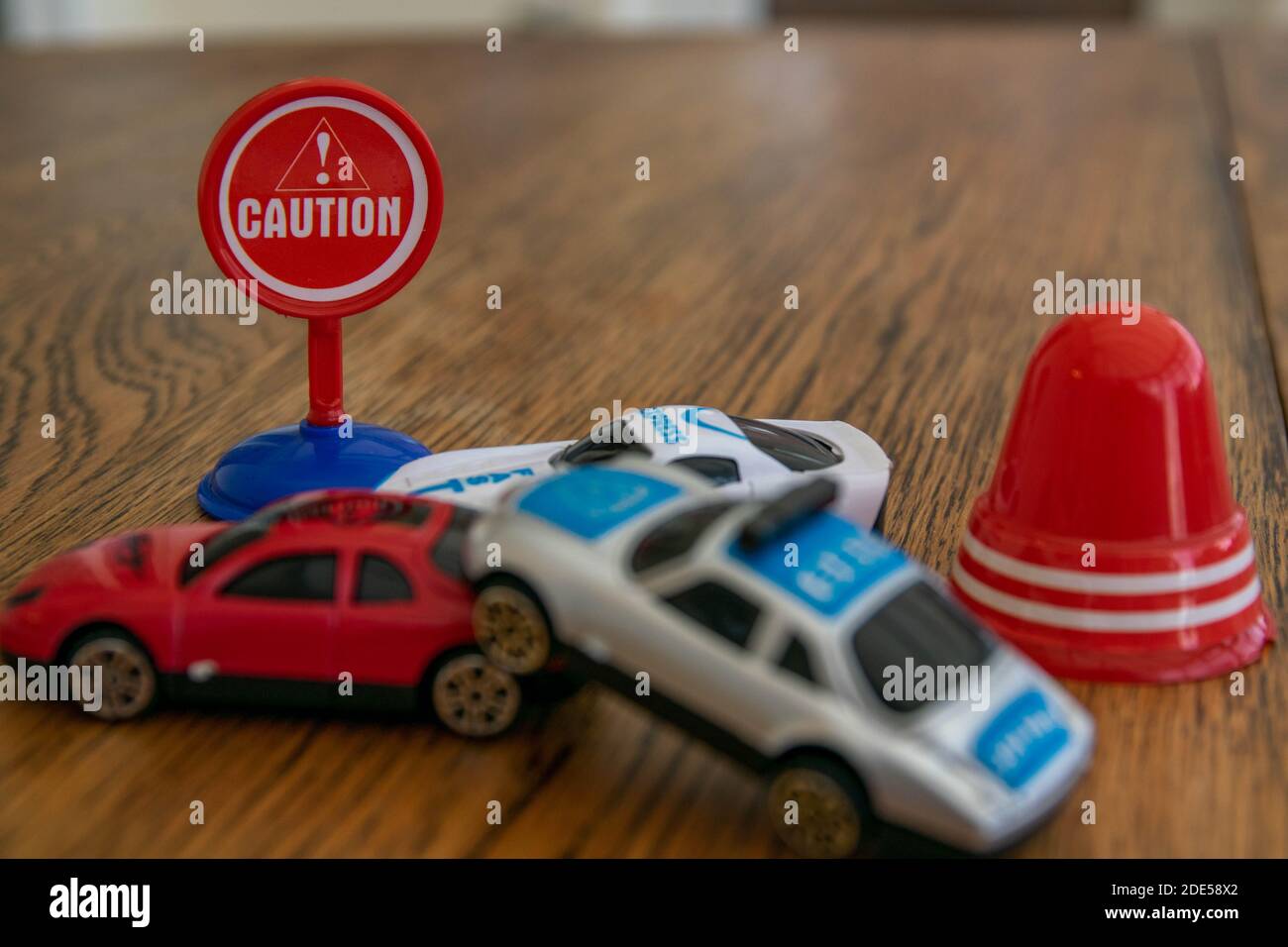 Plastic toys representing a car collision. 3 car pile up, crash, damage, insurance claim, injury, drunk driving, safety whilst driving, bad drivers, d Stock Photo