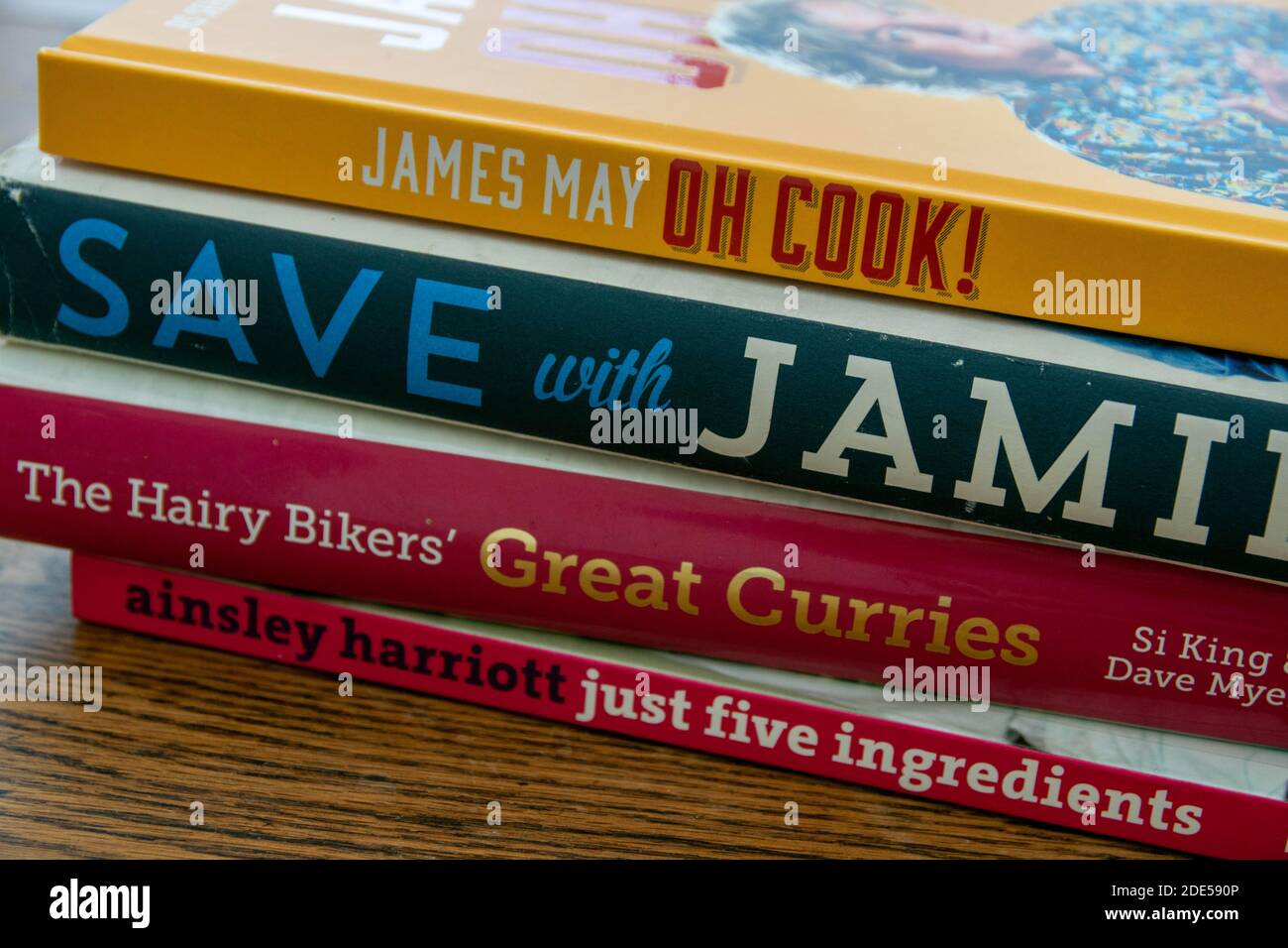 Durham, UK - 17 Nov 2020: Pile of celebrity cookery book, James May, Jamie Oliver, Hairy Bikers and Ainsley Harriott. Home cooking, recipe planning co Stock Photo
