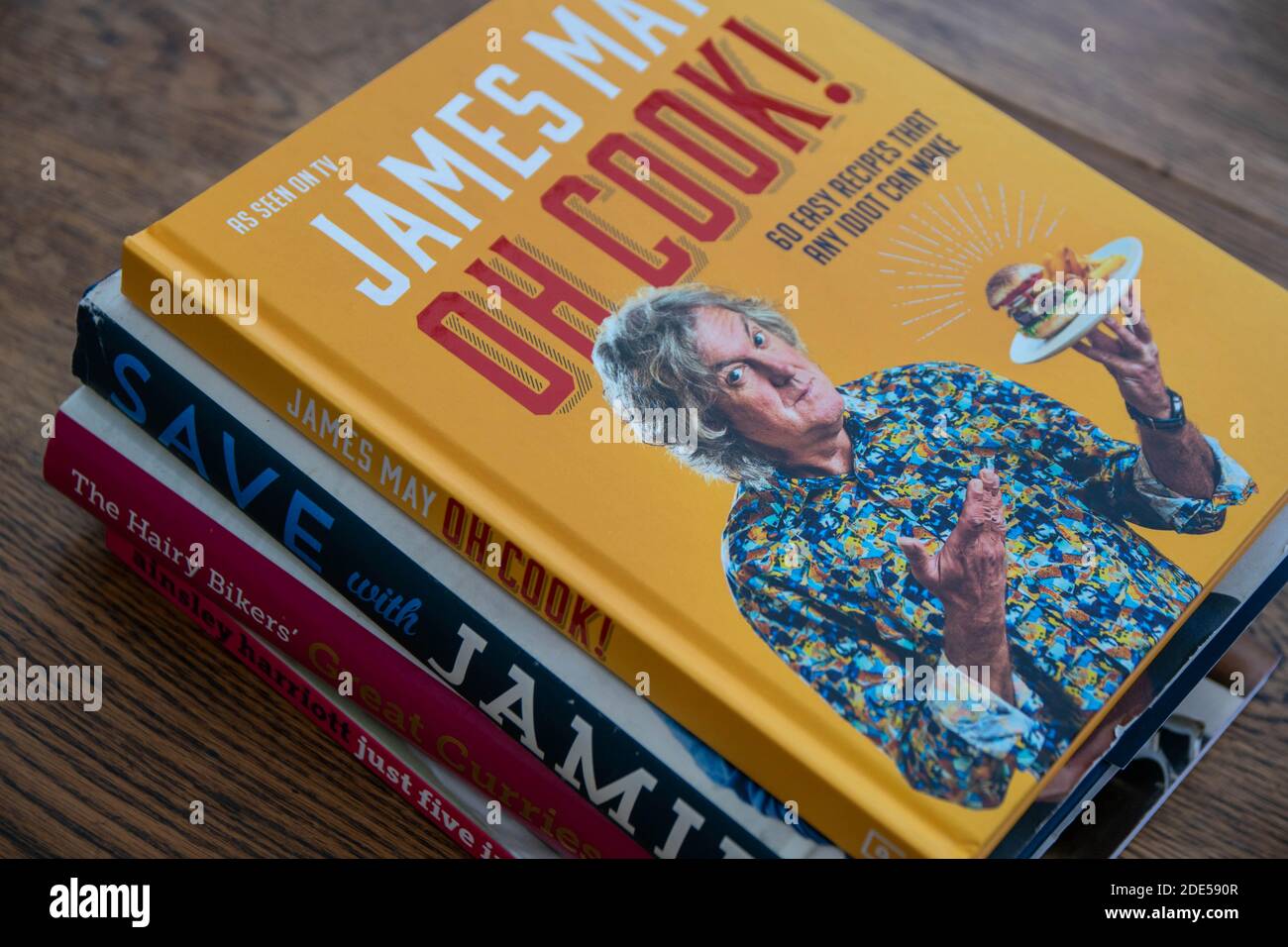 Durham, UK - 17 Nov 2020: Pile of celebrity cookery book, James May, Jamie Oliver, Hairy Bikers and Ainsley Harriott. Home cooking, recipe planning co Stock Photo