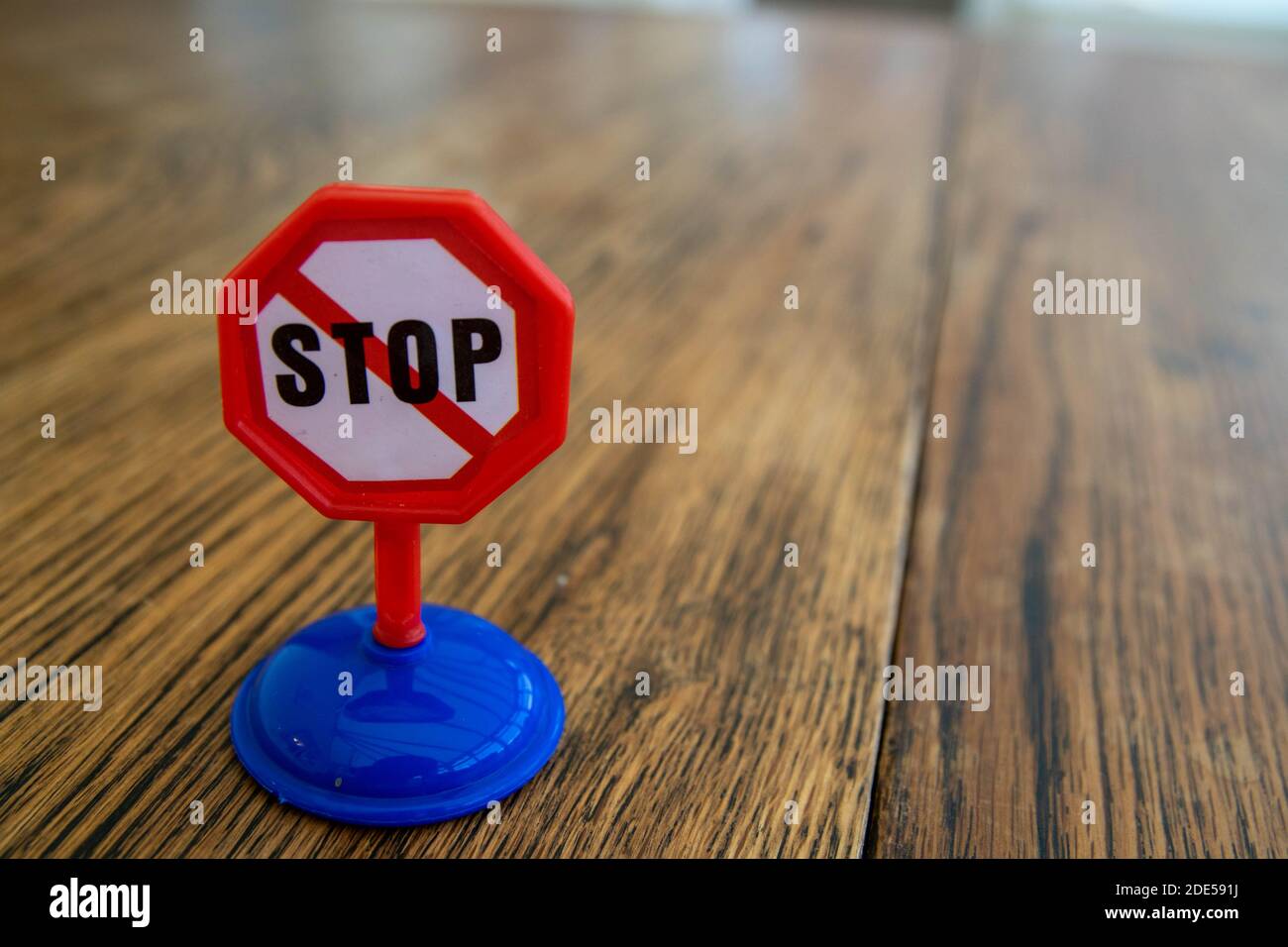 Isolated plastic toy warning sign - STOP. Danger ahead, do not enter, forbidden, construction sight, road sign, signpost concept background. Isolated Stock Photo