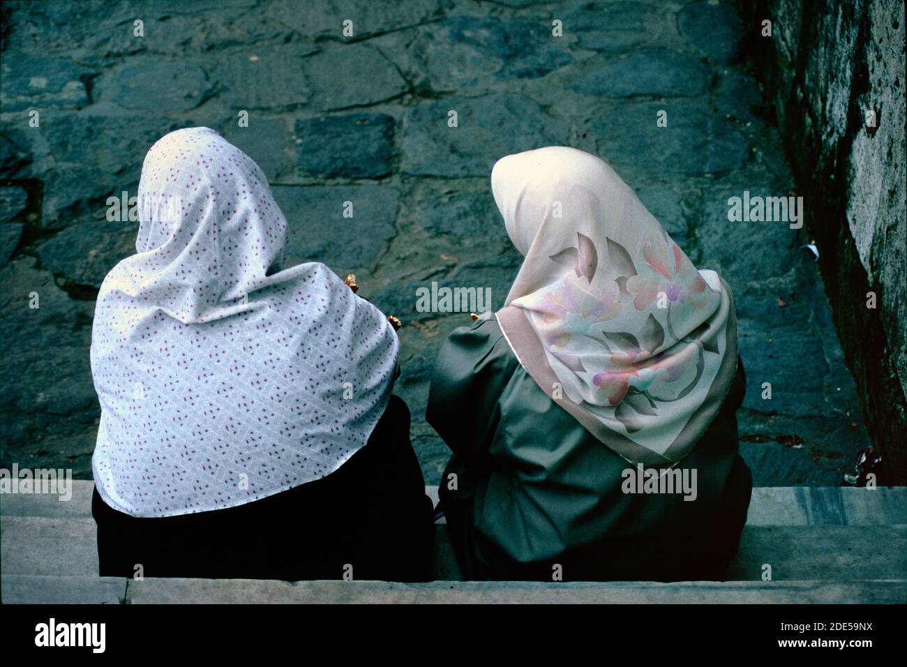 Couple of Traditional Turkish Women Wearing Headscarves & Traditional Dress & Chatting on Doorstep Bursa Turkey Stock Photo