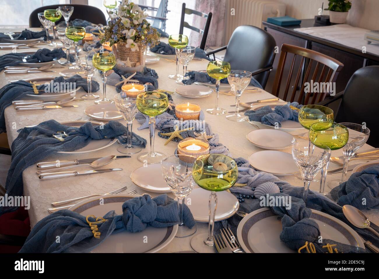 Christmas dinner table decorations in blues and gold following a