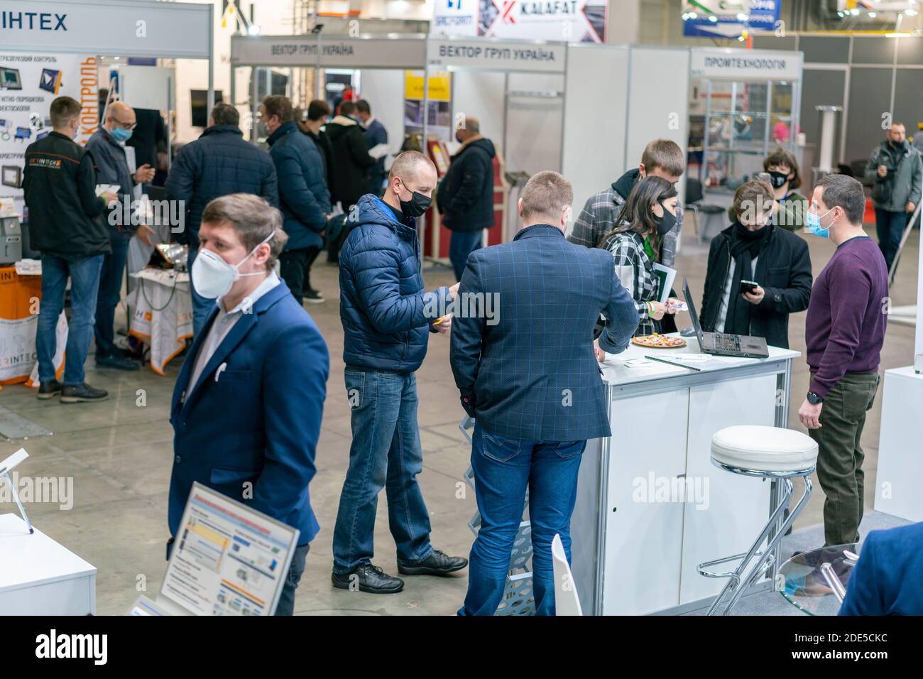 Kiev, Ukraine November 25 2020. Industrial Exhibition during a pandemic. People at the exhibition wearing medical masks. Exhibition and social Stock Photo