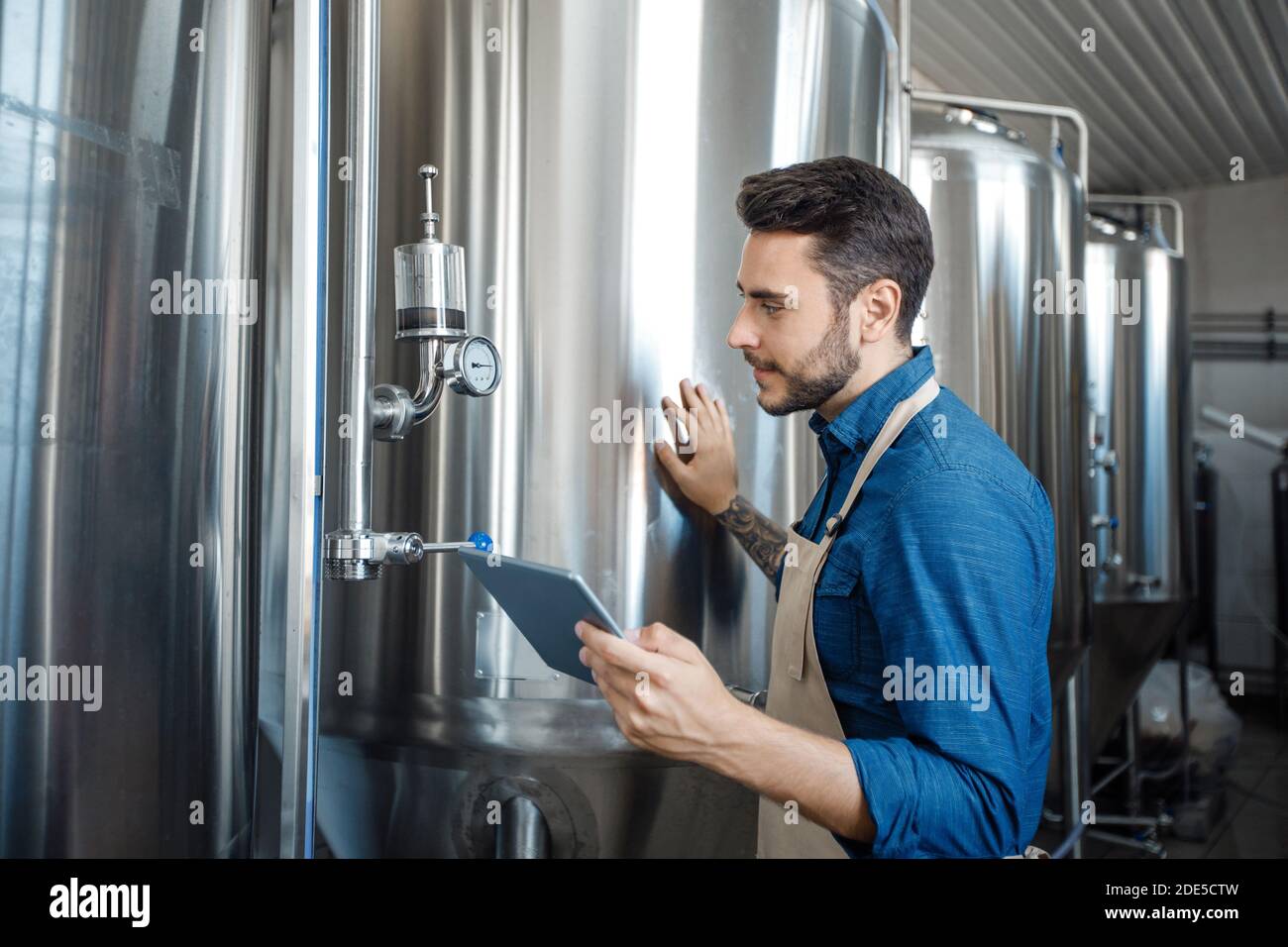 Owner of brewery operations boilers and management in factory Stock Photo