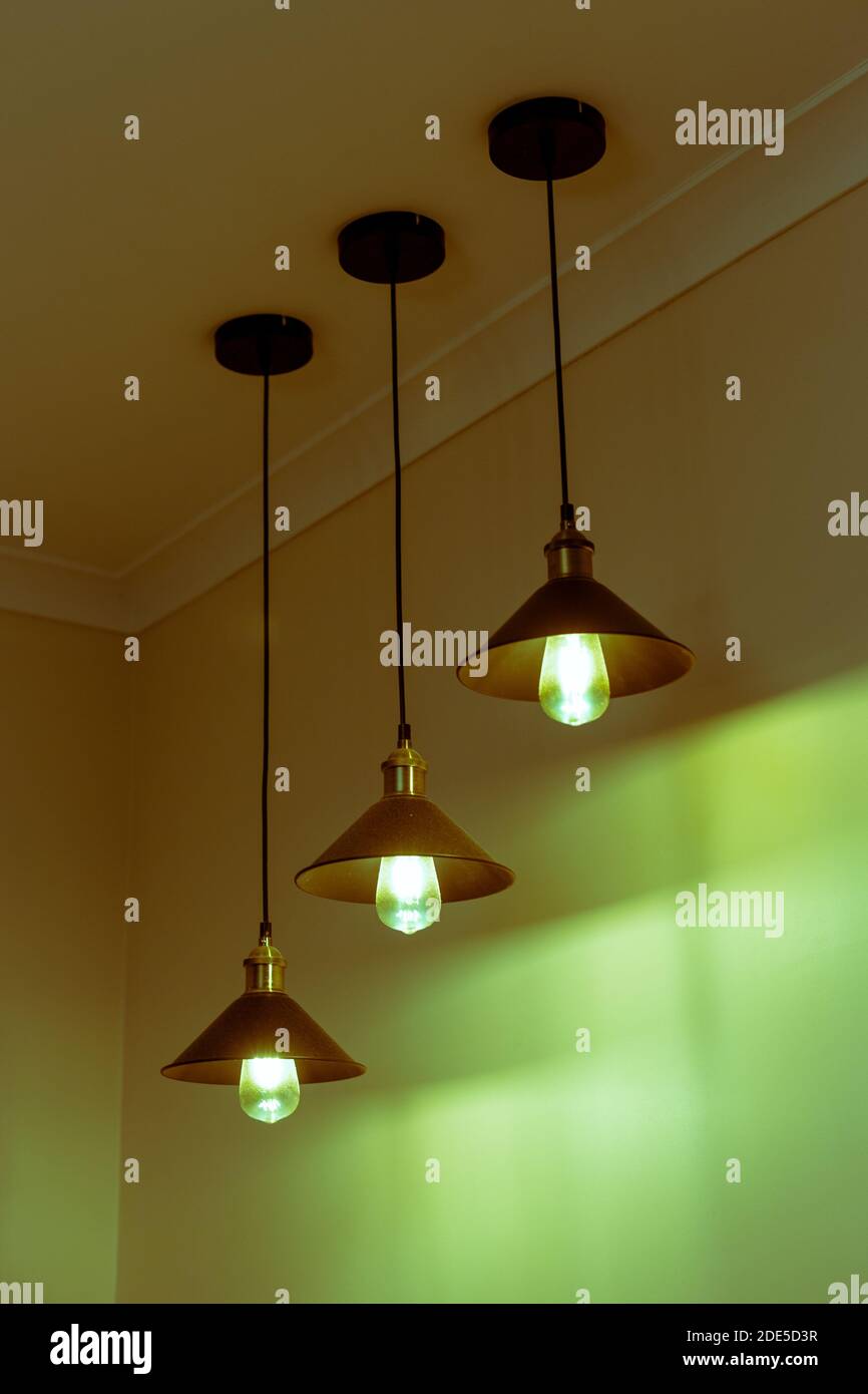 Three lamps with vintage incandescent bulbs with warm light Stock Photo