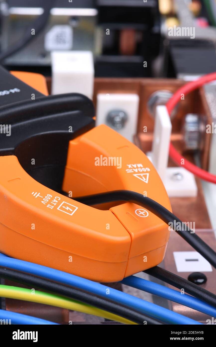 Clamp meter measure current on cable on power supply devices Stock