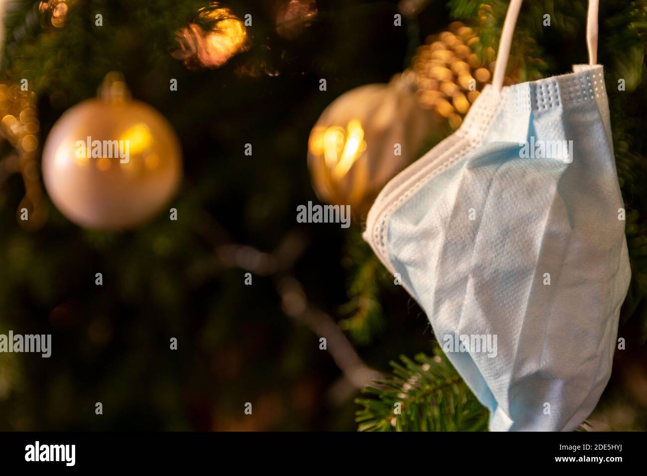 Special christmas tree in 2020 season decorated with face mask due to covid-19 corona pandamic restriction. Stock Photo