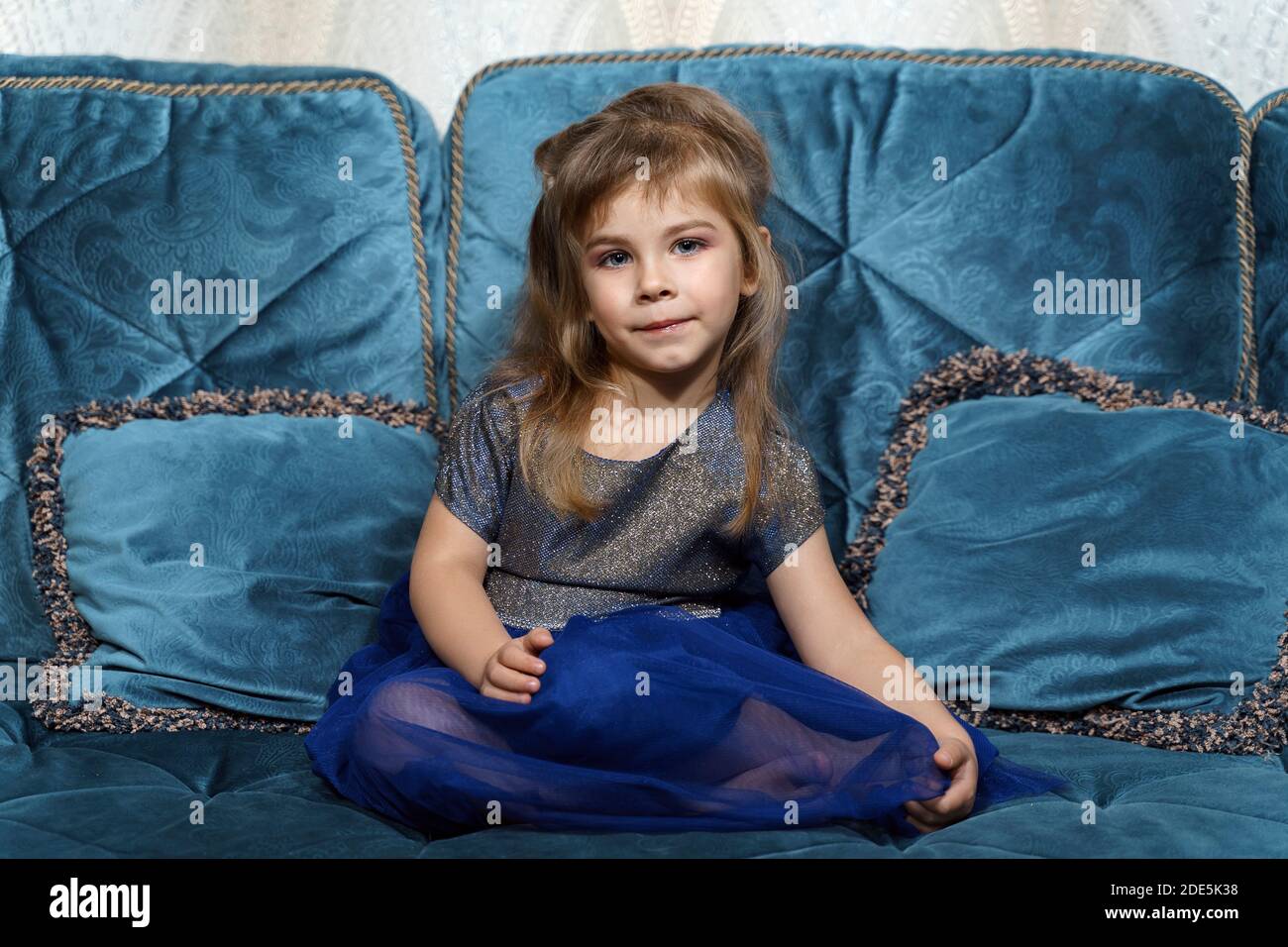 portrait of a beautiful little girl with makeup in a blue dress Stock ...