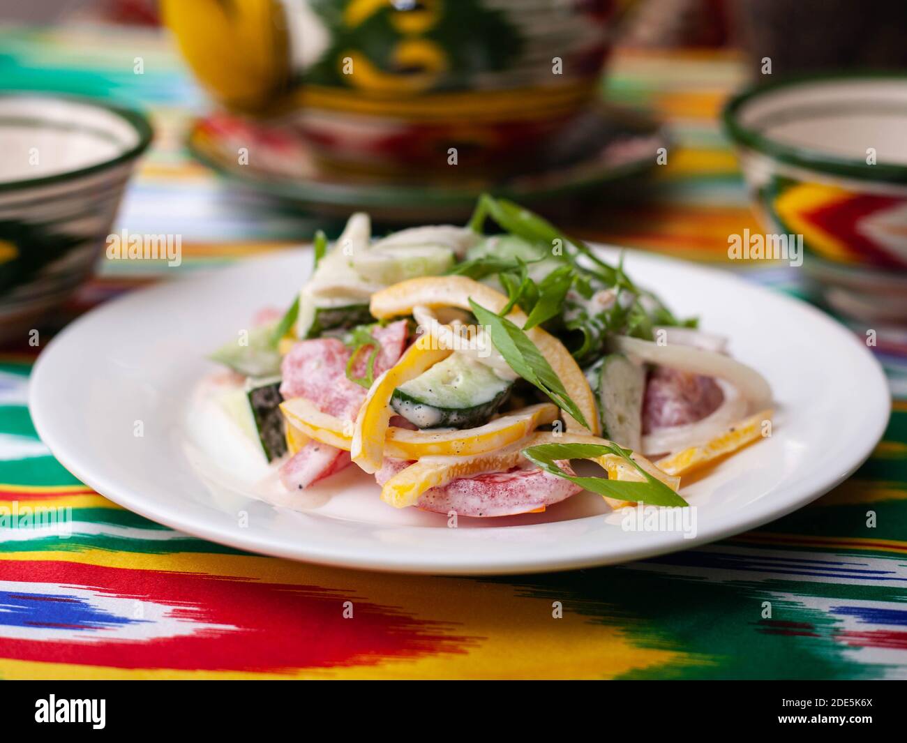 Creamy salad of green and red peppers, cheese, eggplant, onions and