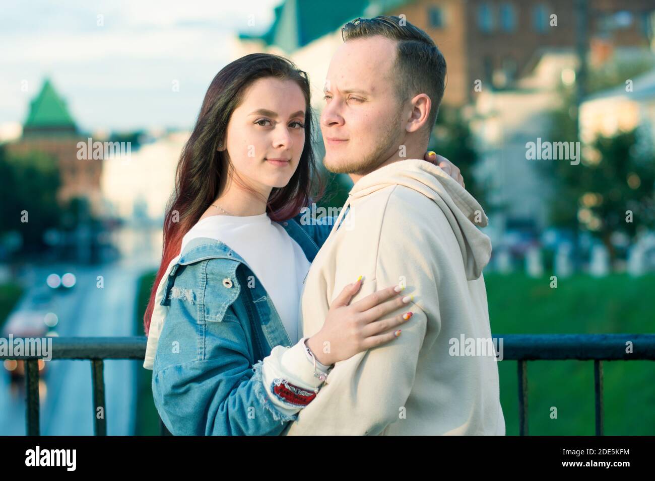 Happy young couple caucasian woman and man is sharing smile and walking ...