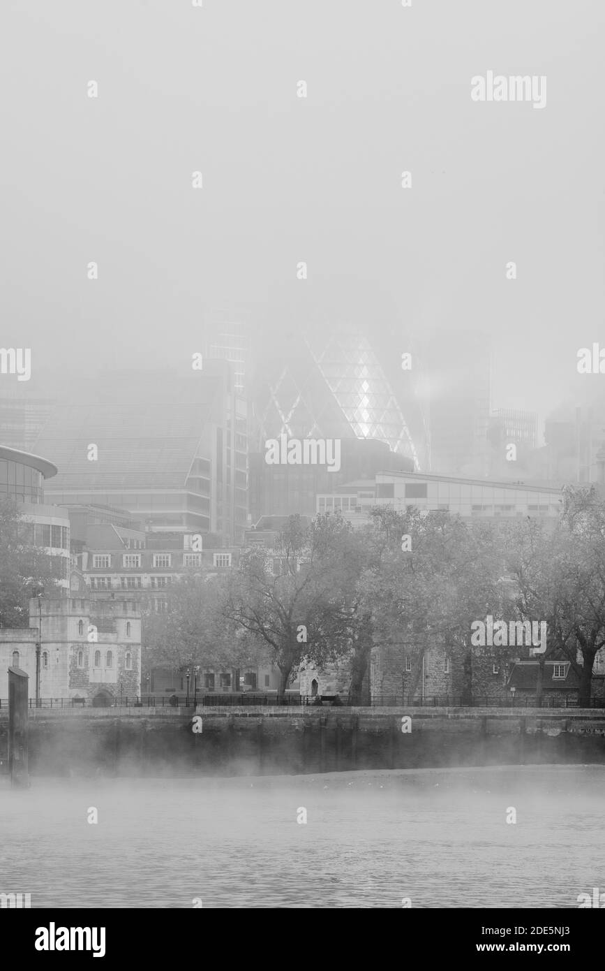 Black and white River Thames and The Gherkin through the mist in City of London on a misty morning of the Covid-19 Coronavirus lockdown in England, UK, Europe Stock Photo