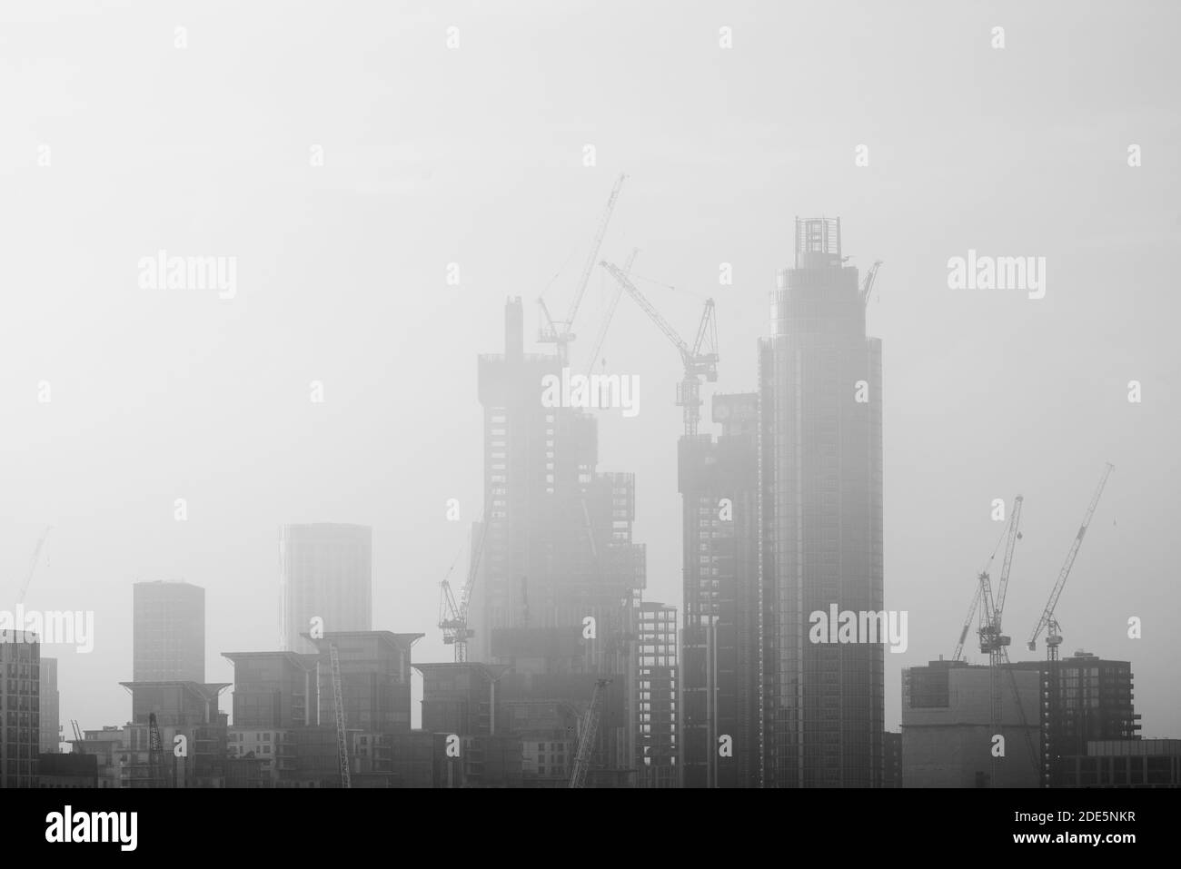 Construction background with copy space in black and white, London cityscape background with tall skyscrapers and office blocks and misty city buildings, England, UK, Europe Stock Photo
