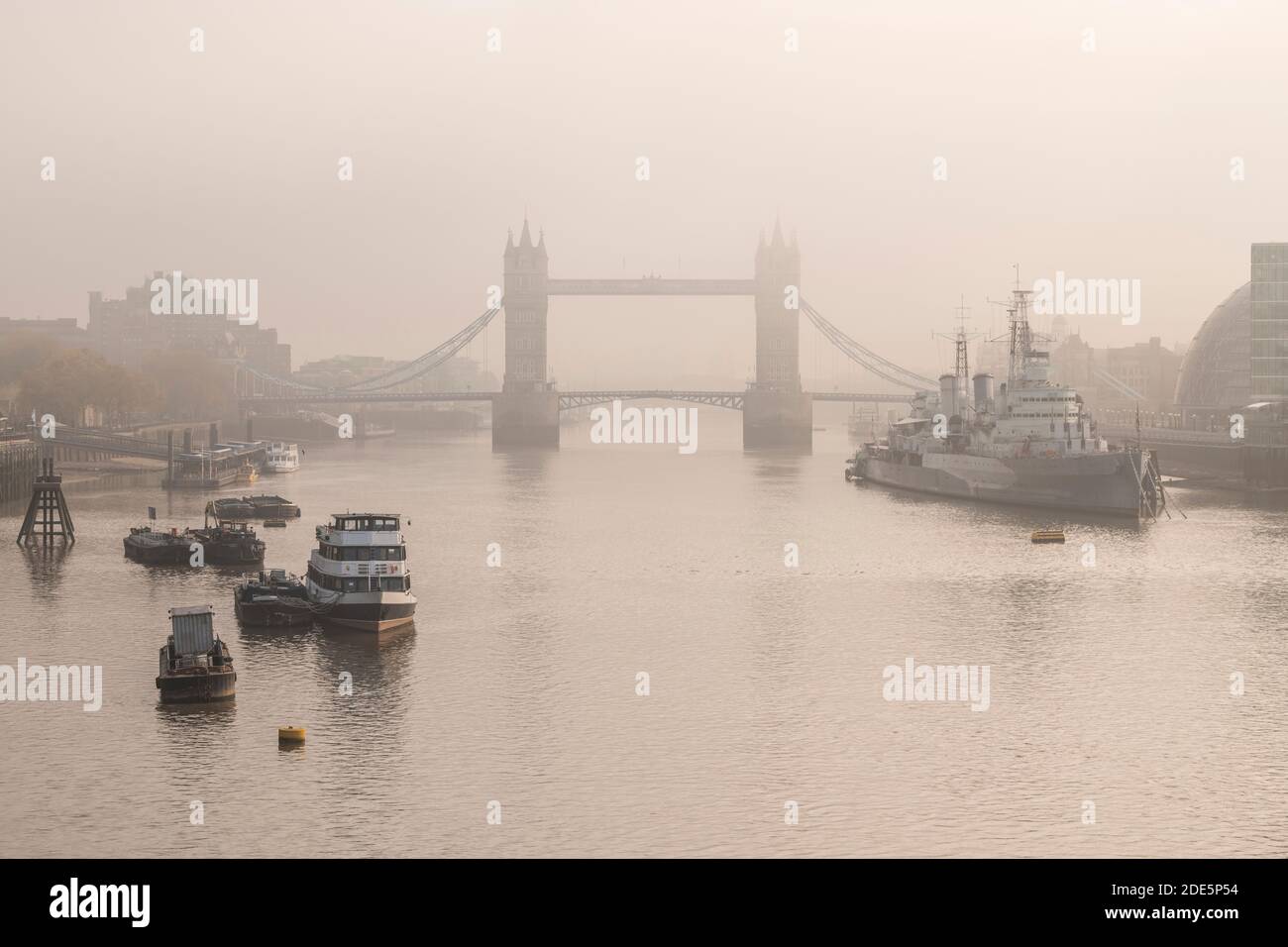 Empty Tower Bridge without traffic in Coronavirus Covid-19 Lockdown in London in foggy misty weather, with the River Thames in beautiful mysterious atmospheric light, England, Europe Stock Photo