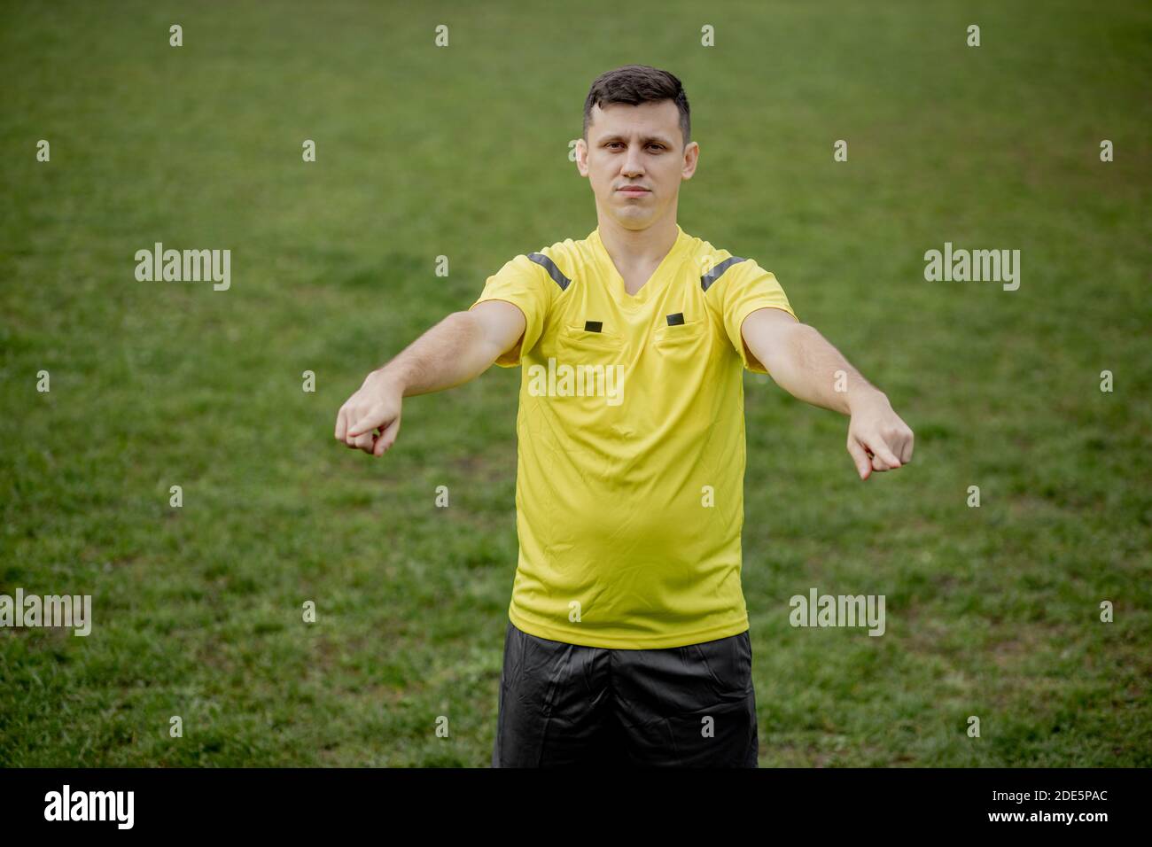 Referee goes watching VAR or violation of the rules. Concept of sport, rules violation, offside Stock Photo