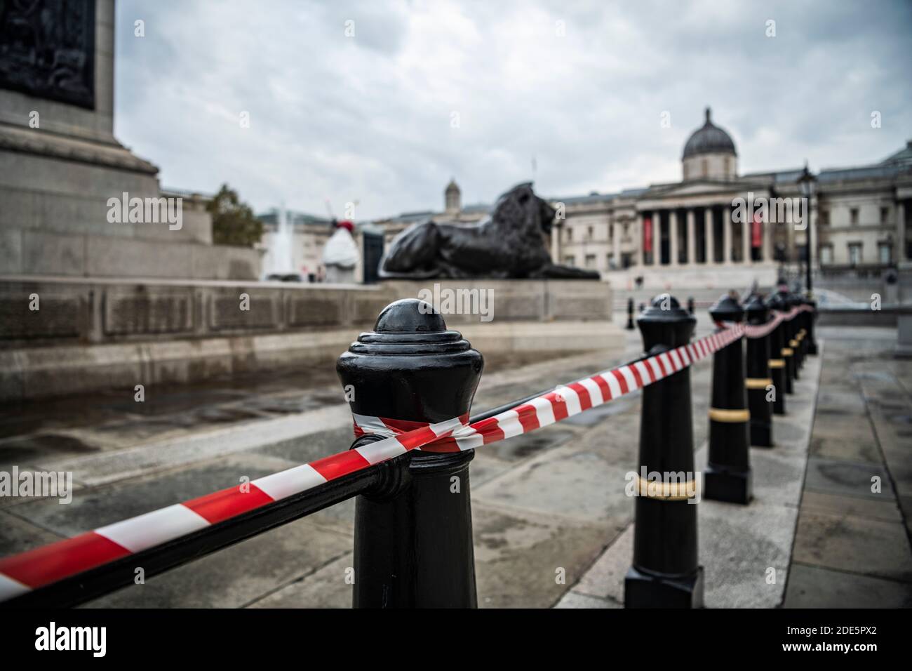 Trafalgar Square lions taped off for health and safety and social distancing in Covid-19 Coronavirus lockdown in London, UK, Europe, with quiet, empty streets in Central London Stock Photo