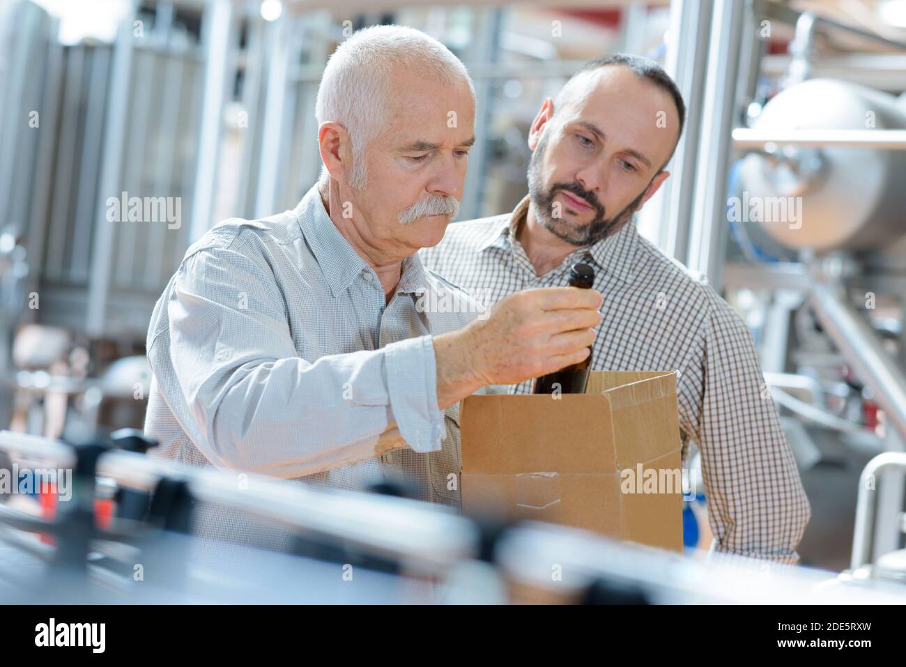 beverage inspectors inspecting a bottle Stock Photo - Alamy