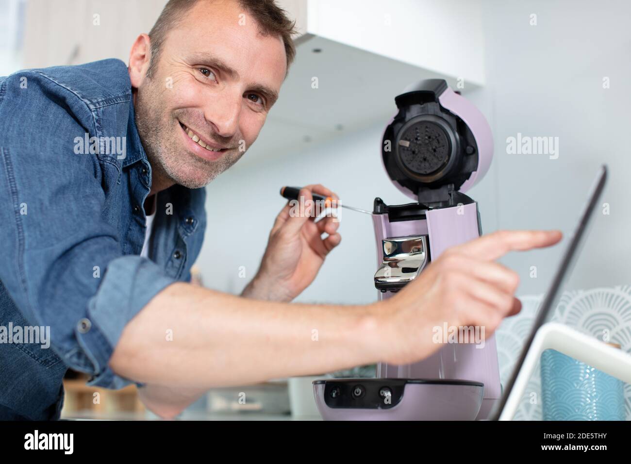 man is fixing coffee machine Stock Photo Alamy