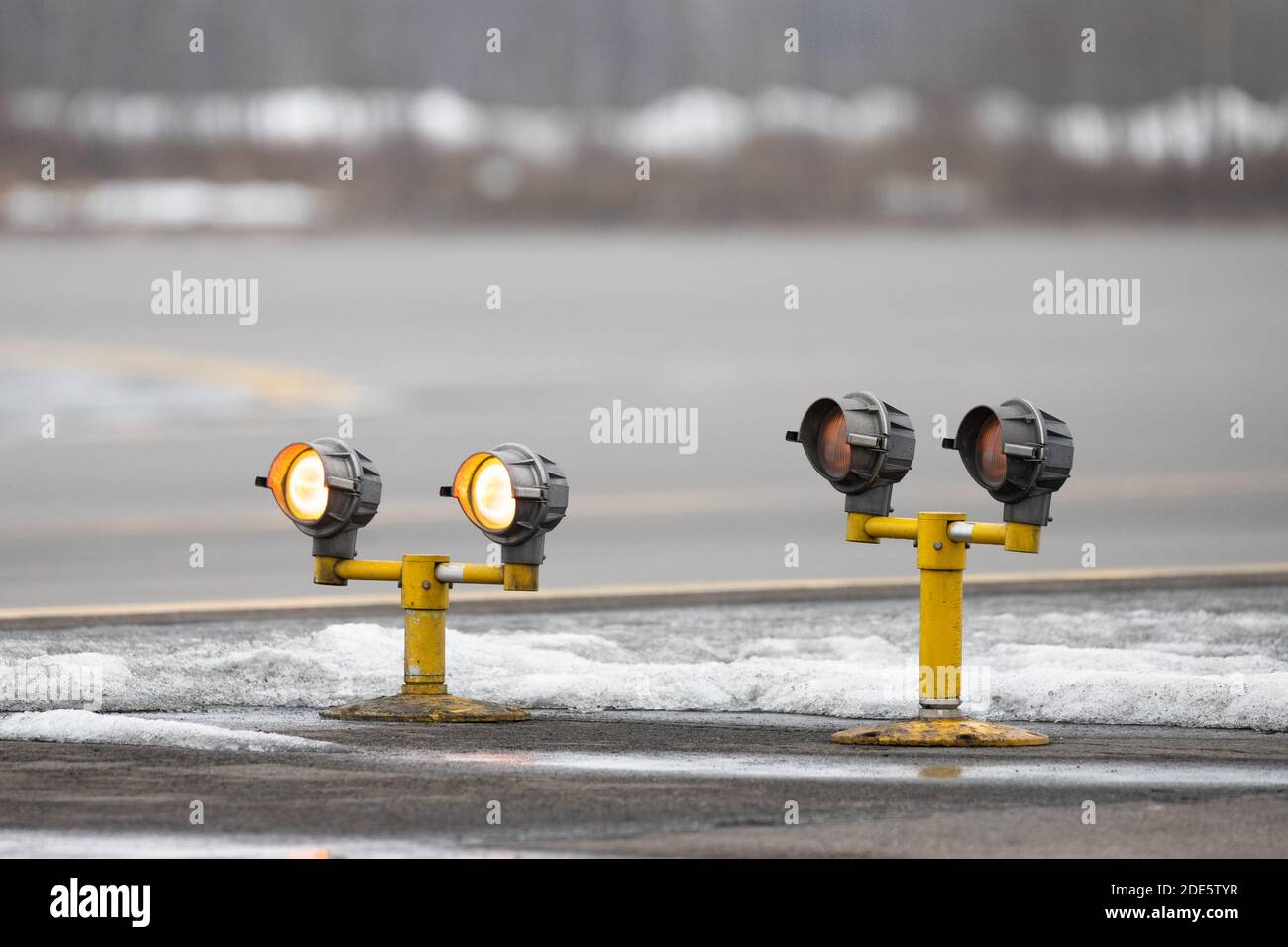Airport runway guarding lights, traffic safety lights in winter time. Stock Photo