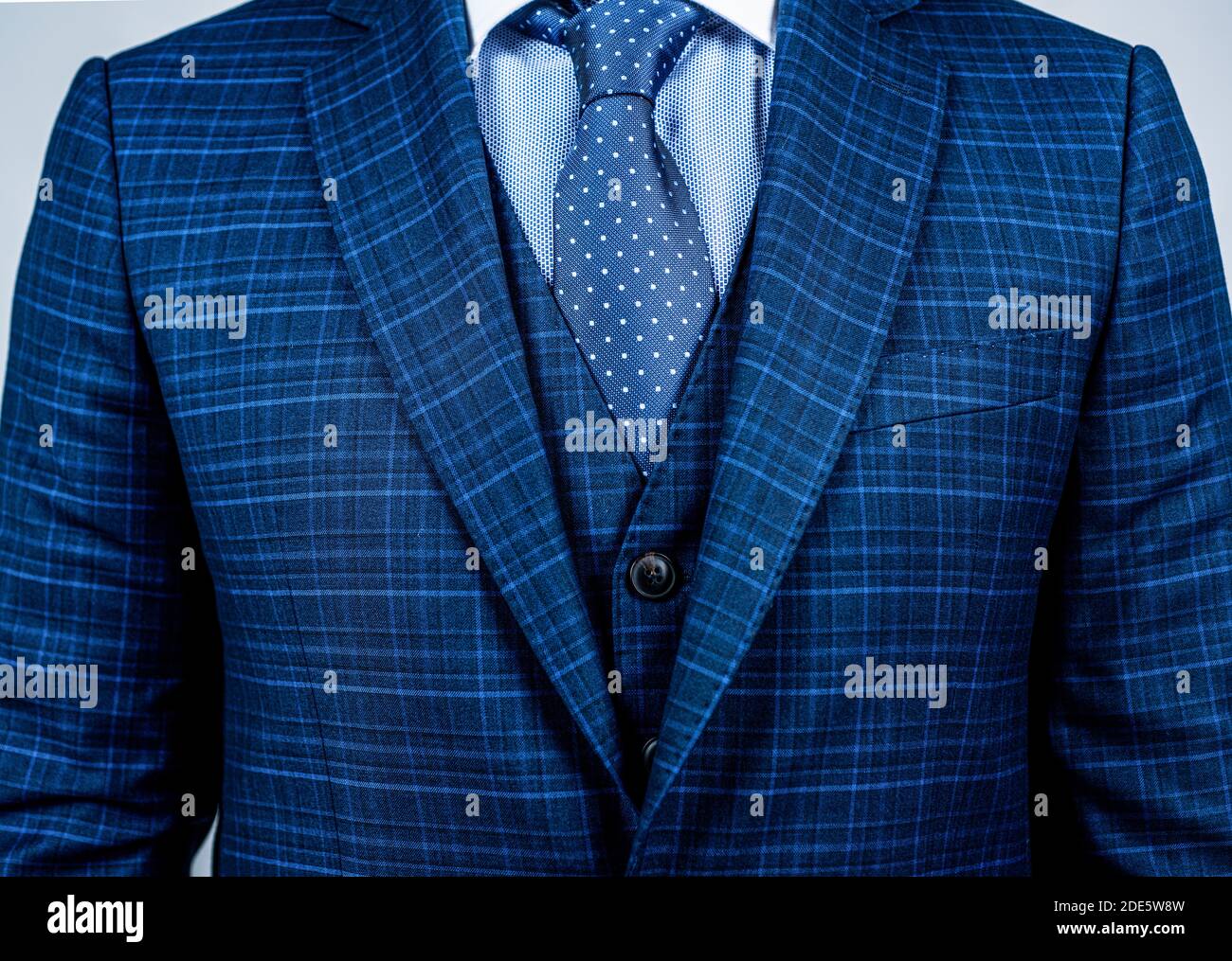 Matching tie with suit. Blue suit worn with classic tie. Necktie