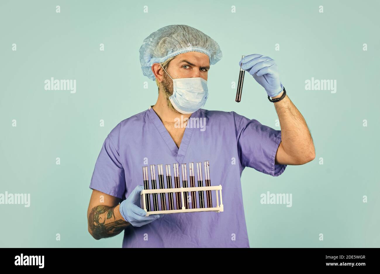 Epidemic disease. Virus concept. Epidemic infection. Genetic analysis. Critical number or density of susceptible hosts. Epidemic threshold. Man in medical lab inspecting samples biological material. Stock Photo