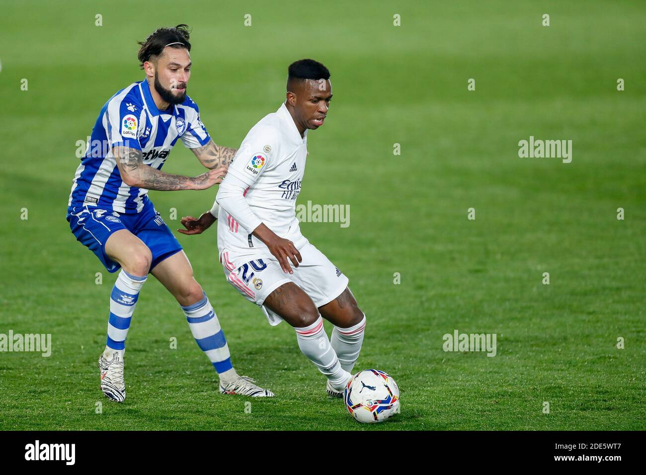 Vinicius Junior of Real Madrid and Jota Peleteiro of Alaves in action during the Spanish championship La Liga football match be / LM Stock Photo