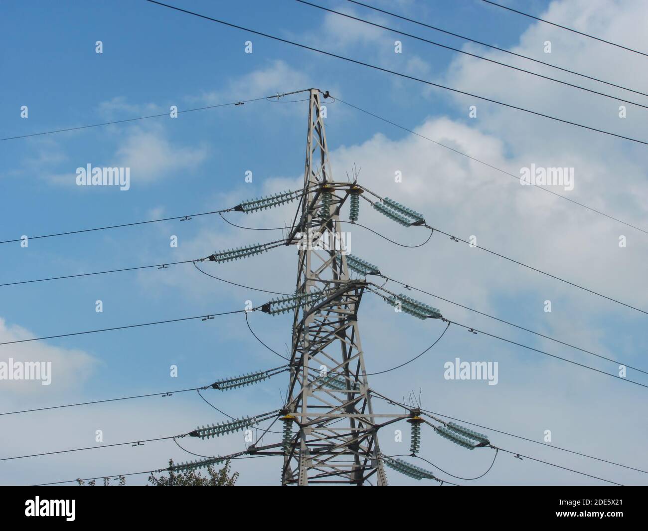 power line support with wires against blue sky with white clouds Stock ...