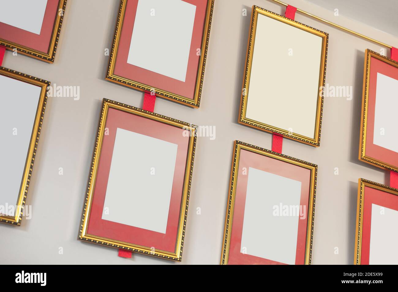 Empty golden frames are on the wall, background texture Stock Photo